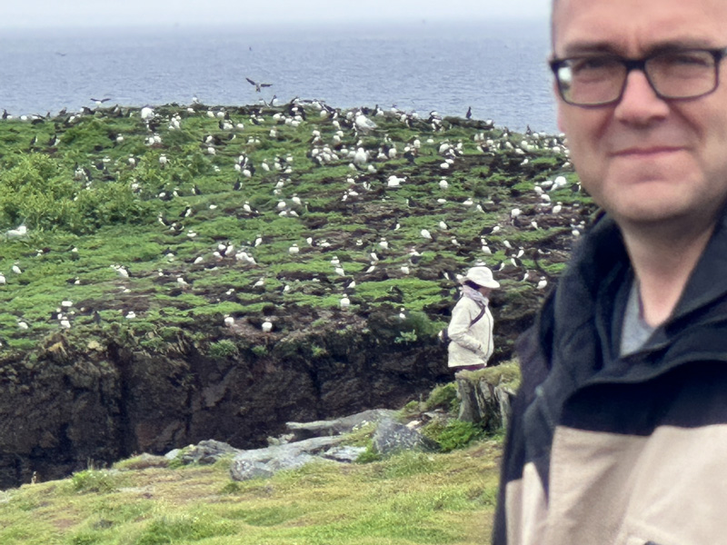 Darren standing in front of bird island in Elliston, Newfoundland
